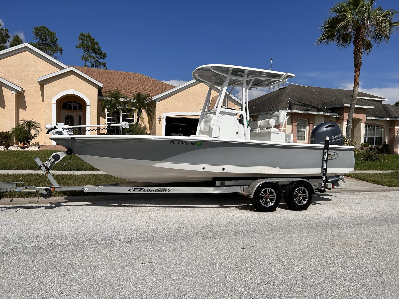 Center console bay boat on a trailer on a residential street