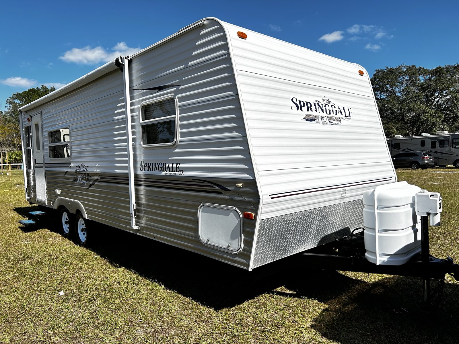 Springdale travel trailer bought for cash in Central Florida under a bright blue sky